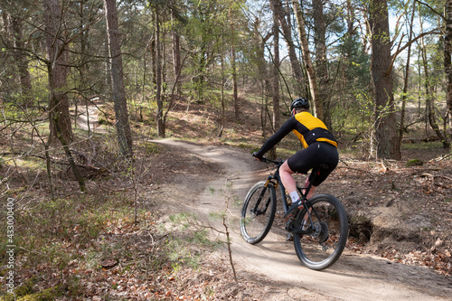 man on mountain bike in spring forest near utrecht in holland