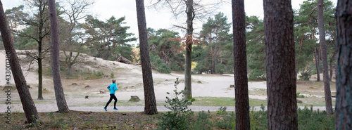 Photography woman runs in forest near utrecht in the netherlands