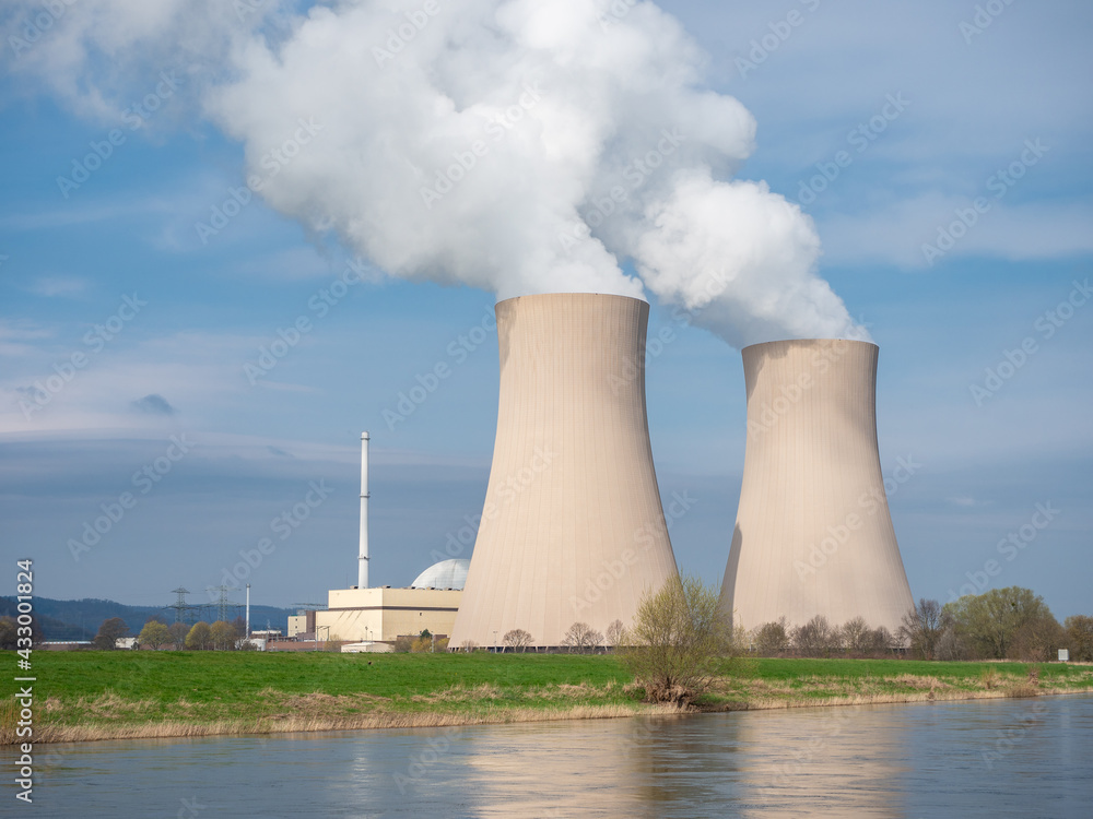 Nuclear power plant against sky by the river at sunset Nuclear power plant against sky by the river at sunset