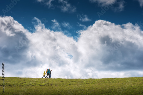 Family hikers against cloudy sky