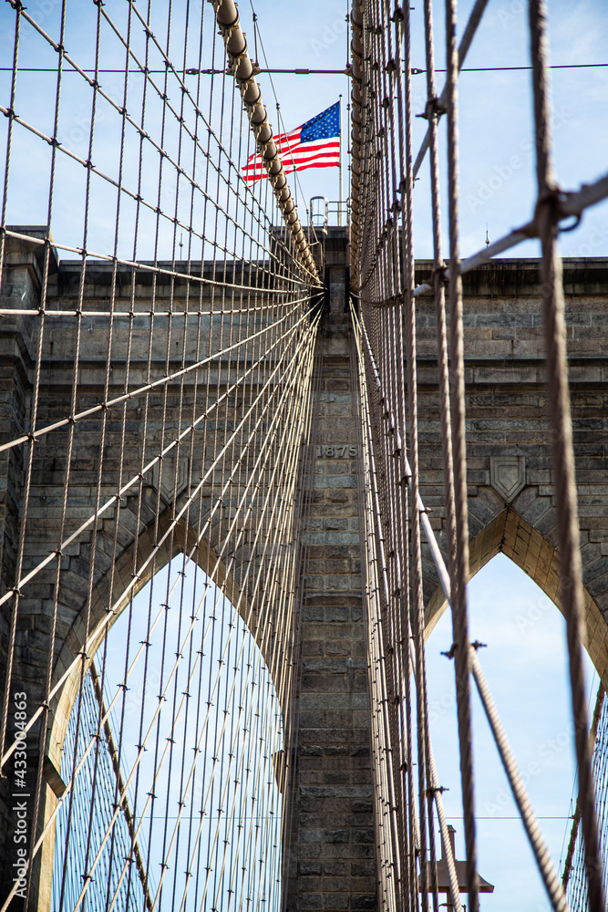Fototapeta premium Abstract view of the American Flag and the Brooklyn bridge in the USA