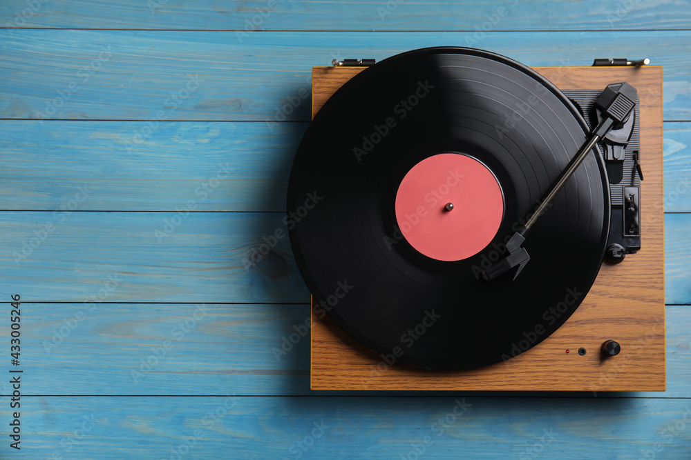 Modern vinyl record player with disc on blue wooden background, top view. Space for text - obrazy, fototapety, plakaty 