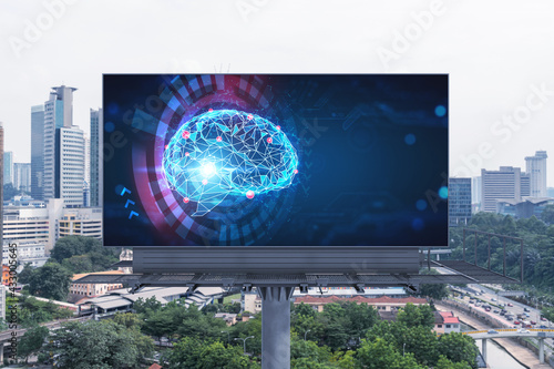 Brain hologram on billboard with Kuala Lumpur cityscape background at day time. Street advertising poster. Front view. KL is the largest science hub in Malaysia, Asia. Coding and high-tech science.