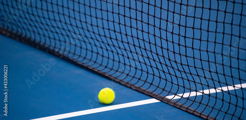  Tennis net and ball and hard court. Professional sport and tennis competition concept