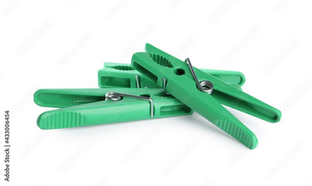 Bright green plastic clothespins on white background Bright green plastic clothespins on white background