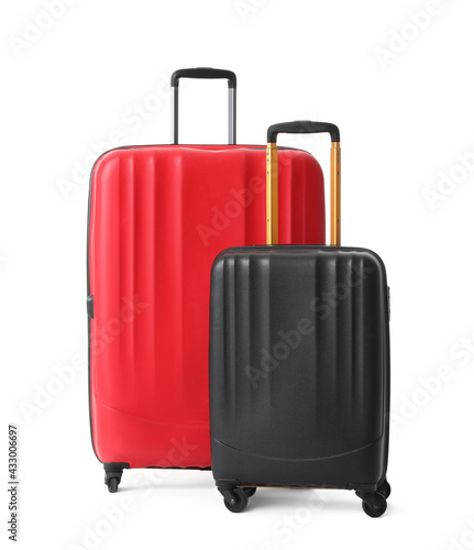 Modern suitcases for travelling on white background