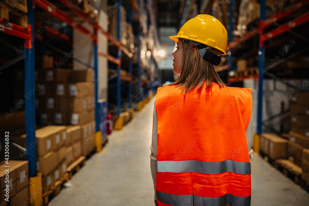 Warehouse employe walking through aisle Warehouse employe walking through aisle