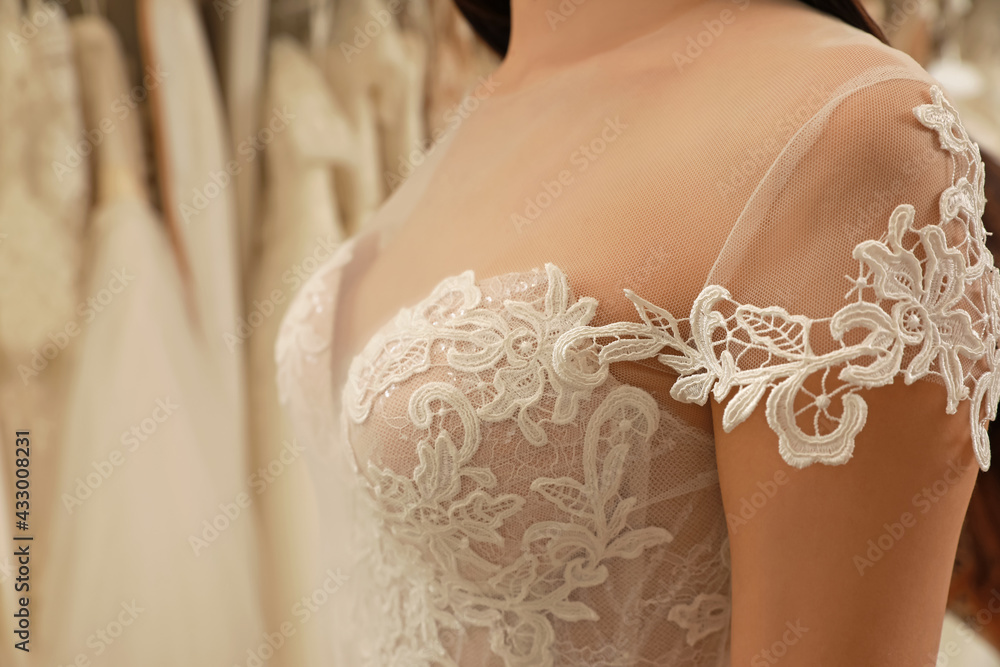 Woman trying on wedding dress in boutique, closeup Woman trying on wedding dress in boutique, closeup