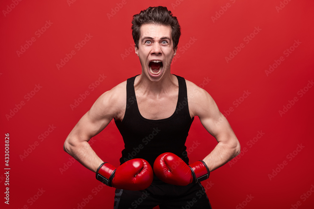 Funny angry fighter in boxing gloves