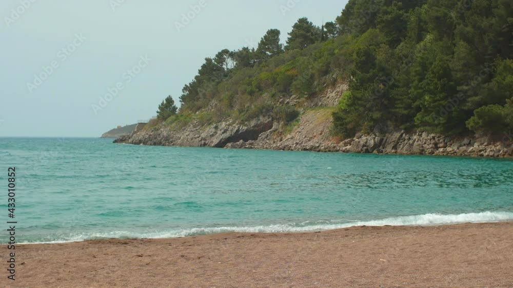Landscape view of the beach on Adriatic sea and green trees on the mountains Landscape view of the beach on Adriatic sea and green trees on the mountains