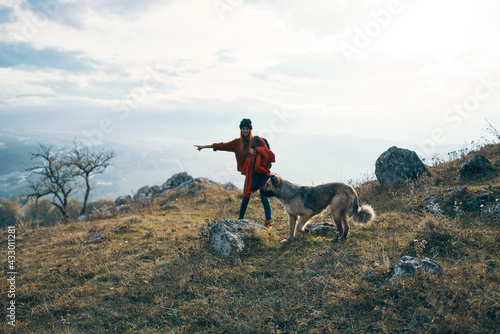 woman hiker with dog on nature travel mountains landscape fun