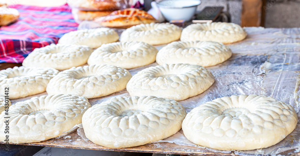 Traditional uzbek round flat bread is preparing to put in the tandyr Traditional uzbek round flat bread is preparing to put in the tandyr