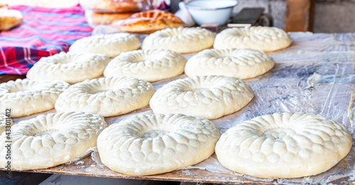 Traditional uzbek round flat bread is preparing to put in the tandyr © Alexandr Blinov