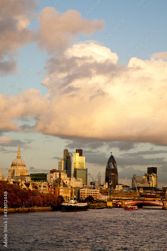Vertical portrait of the London skyline with St Pauls in evening warm light Vertical portrait of the London skyline with St Pauls in evening warm light