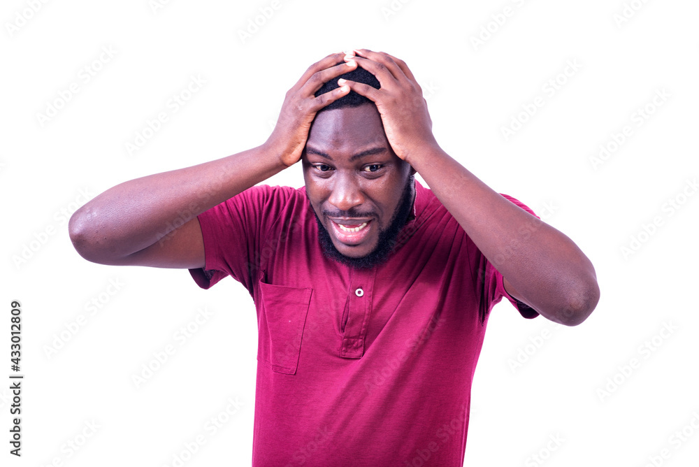 handsome frustrated young man holding head with two hands. handsome frustrated young man holding head with two hands.