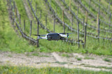 drone with integrated video camera in flight in countryside