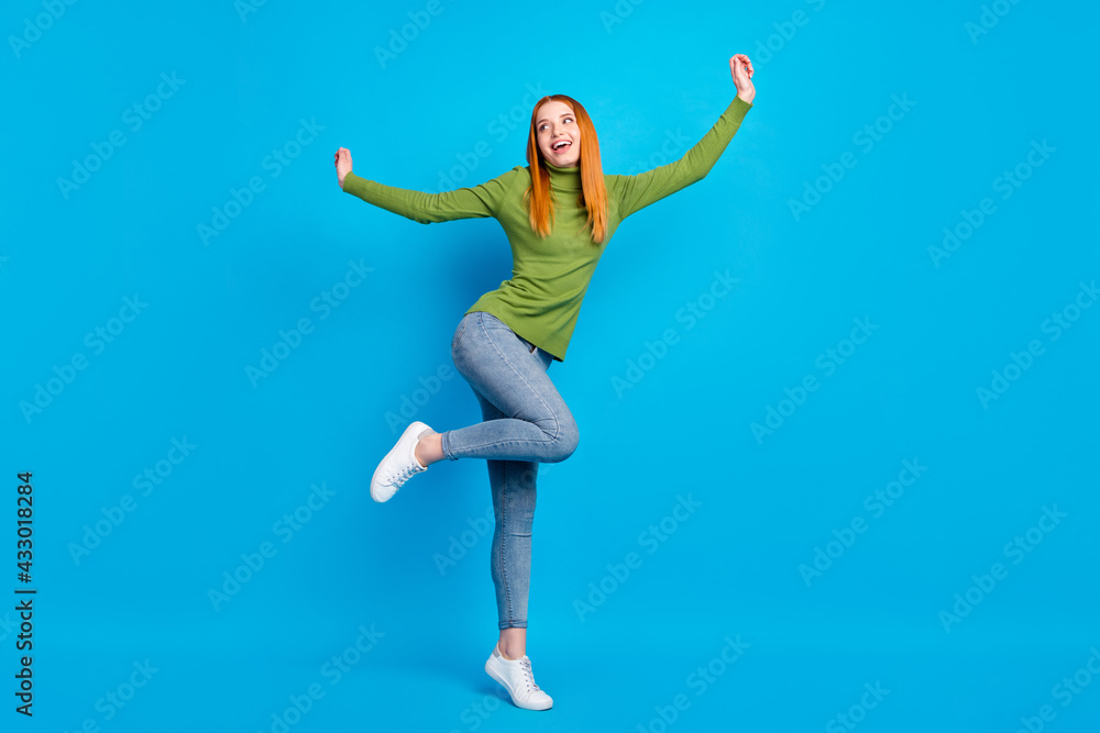 Full length body size view of pretty carefree cheerful funny girl jumping having fun dancing isolated over bright blue color background