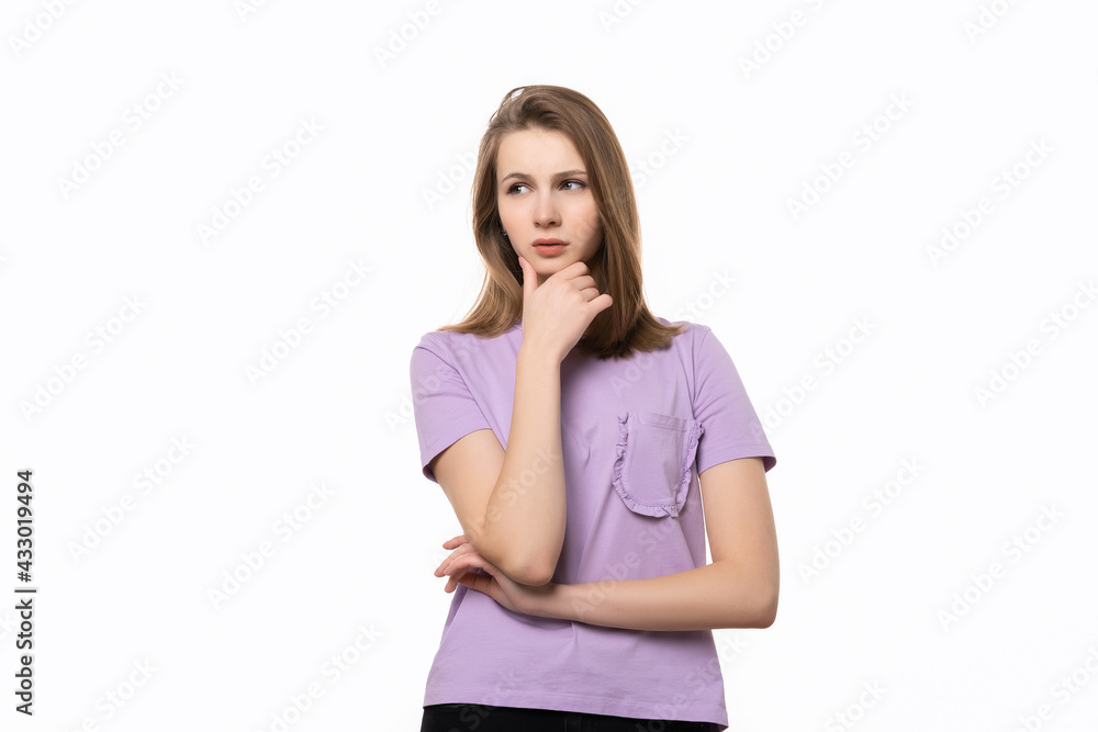 young pretty woman looking thinking with hand on chin, wondering or asking a question young pretty woman looking thinking with hand on chin, wondering or asking a question