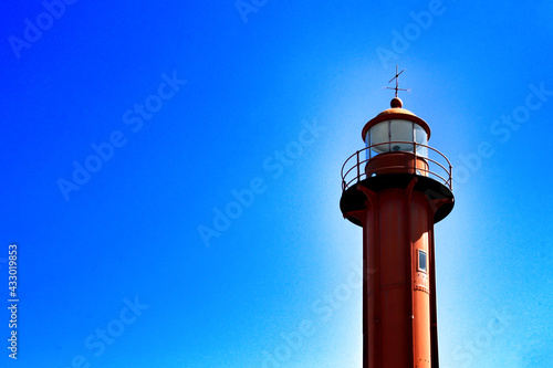 Red lighthouse in the port of Almada village in Lisbon