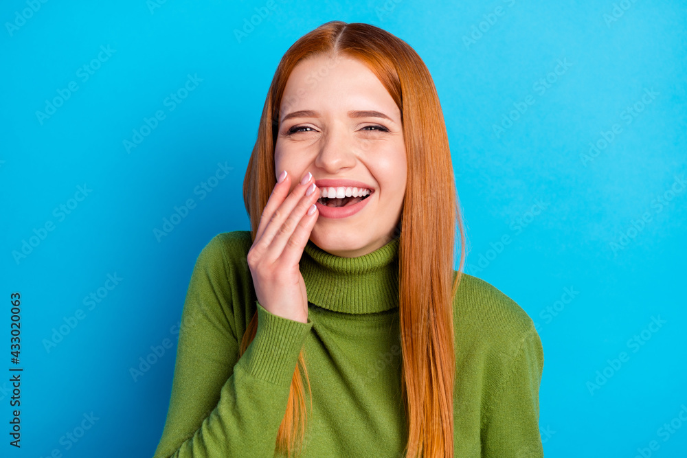 Portrait of charming cheerful girl laughing having fun good mood isolated over bright blue color background Portrait of charming cheerful girl laughing having fun good mood isolated over bright blue color background