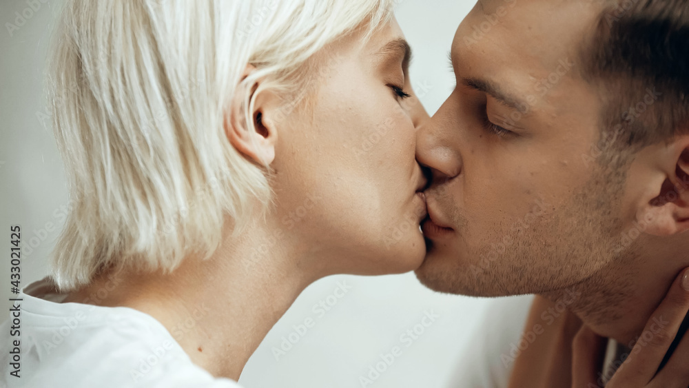 close up of couple with closed eyes kissing at home close up of couple with closed eyes kissing at home