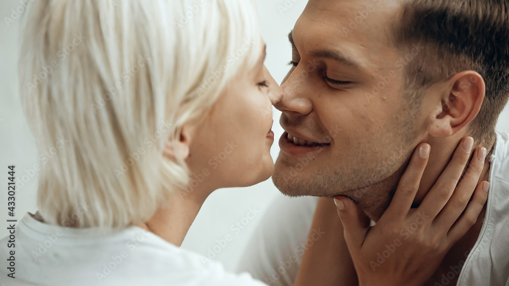 close up of happy young couple kissing at home close up of happy young couple kissing at home