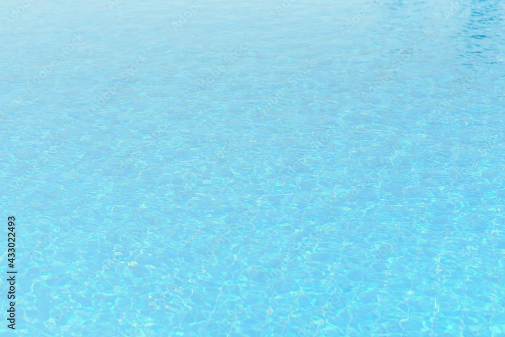 Hotel swimming pool with sunny reflections