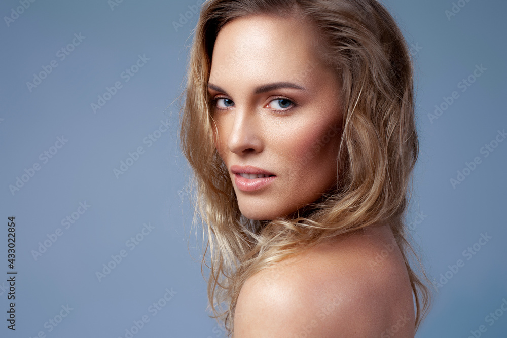 Beautiful blonde with wavy hair close up. Skin care, nude makeup Beautiful blonde with wavy hair close up. Skin care, nude makeup