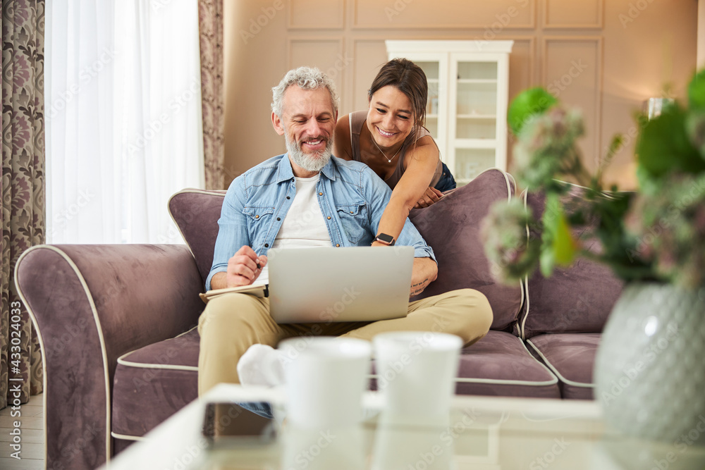 Beautiful female person pointing at screen of laptop Beautiful female person pointing at screen of laptop