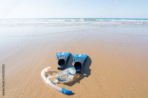 diving and snorkeling equipment on the sand of the beach. fins, mask and snorkel. leisure and water sports concept