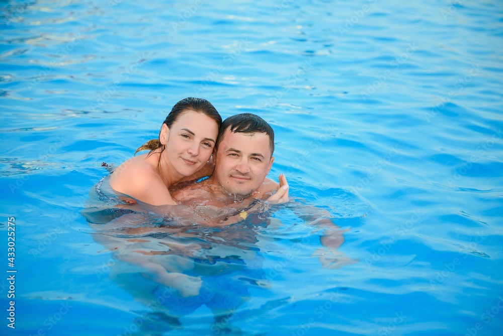 Portrait of a smiling couple in a swimming pool