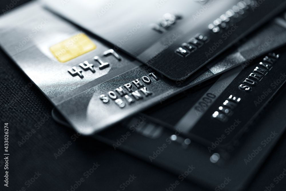 Stack credit cards, close up view with selective focus for background. Online credit card payment.