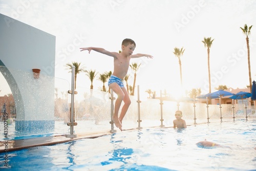 Boy jumping in swimming pool