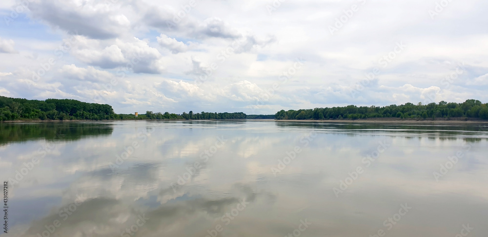 Landscape of a wide river with clouds on a gray, autumn day. Panorama. Landscape of a wide river with clouds on a gray, autumn day. Panorama.