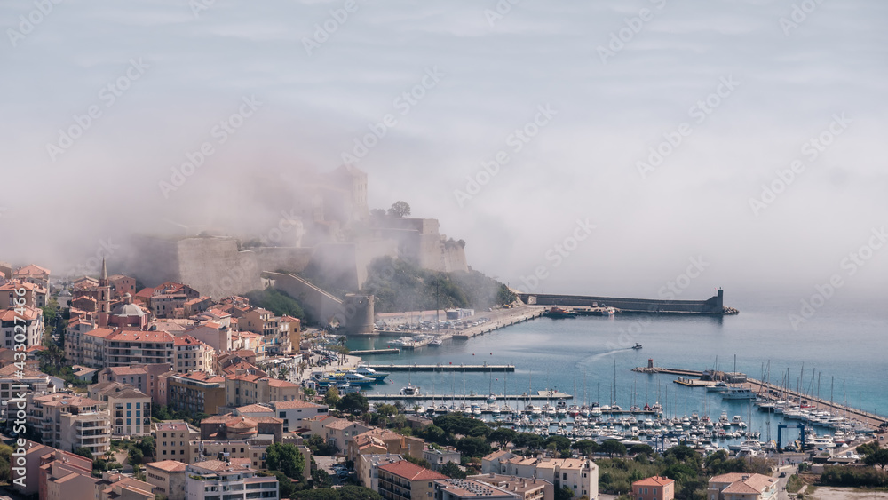 Citadel of Calvi in the mist in Corsica