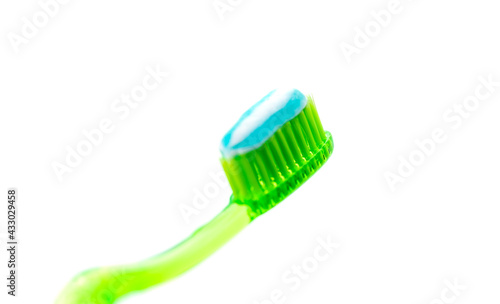 Toothbrush with paste on white background