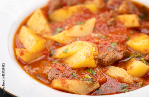 Meat sauce with potatoes in a plate