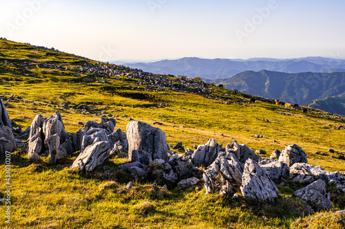 Papier peint Dramatic Landscape of Many Rocks and Stones on The Grassy Field under The Sky in