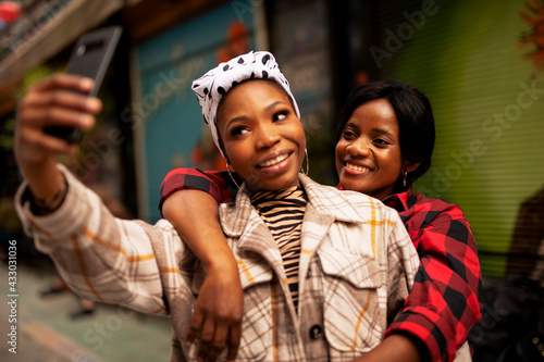 Portrait of a happy smiling female friends. Beautiful happy girlfriends taking a selfie together