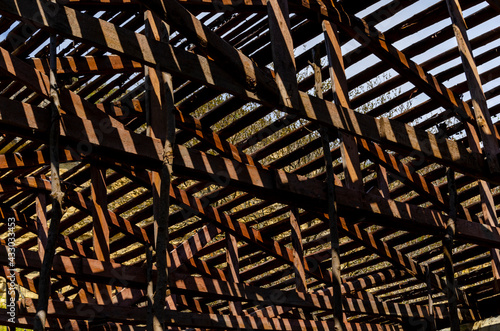 old wooden slats with sun shining through. light through the roof