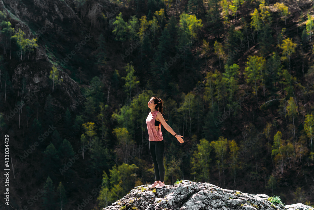 Healthy lifestyle and relaxation concept. Yoga in the fresh air. Happy woman doing yoga exercises. Meditation and relaxation. A woman practicing yoga in the mountains. A woman meditates in nature Healthy lifestyle and relaxation concept. Yoga in the fresh air. Happy woman doing yoga exercises. Meditation and relaxation. A woman practicing yoga in the mountains. A woman meditates in nature