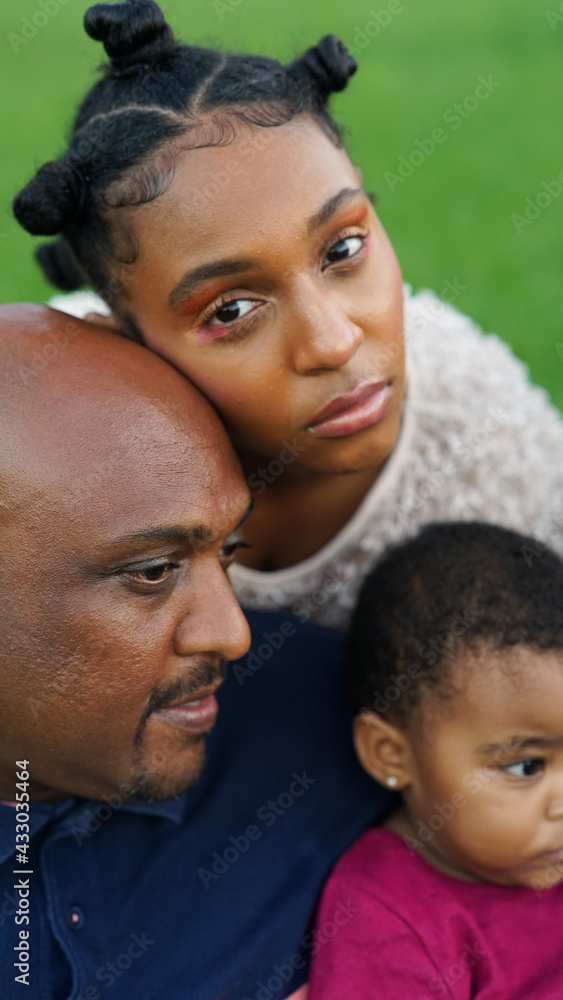 Family Portrait of Father and Daughters relaxing on Grassy Backyard Family Portrait of Father and Daughters relaxing on Grassy Backyard