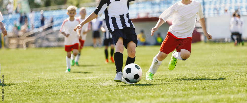Group of Boys Playing Football League Match. Football Players Running on Tournament Game Group of Boys Playing Football League Match. Football Players Running on Tournament Game