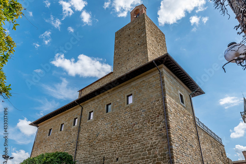 The outer walls of the imposing castle of the Conti Guidi in the historic center of Vinci, Florence, Italy, against a beautiful sky