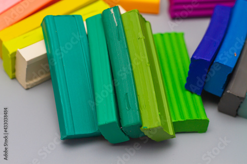 Tableau sur toile Pieces of new multi-colored plasticine for modeling and molding children at scho