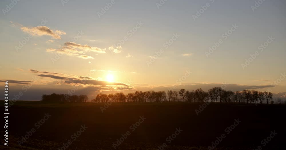 Beautiful sunset on a background of trees. Timelapse clouds Beautiful sunset on a background of trees. Timelapse clouds