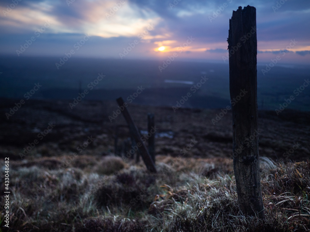 Old fence posts going down side of mountain in Ireland Old fence posts going down side of mountain in Ireland