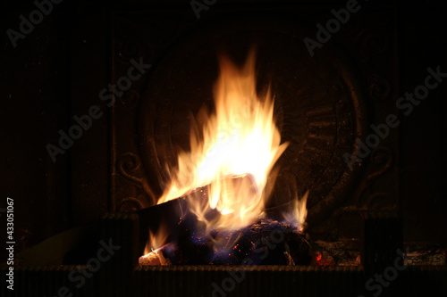 Firewood burns in the fireplace. Shooting at night. Closeup