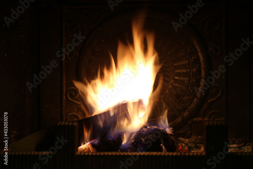 Firewood burns in the fireplace. Shooting at night. Closeup