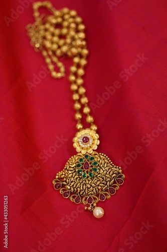 golden necklace on silk